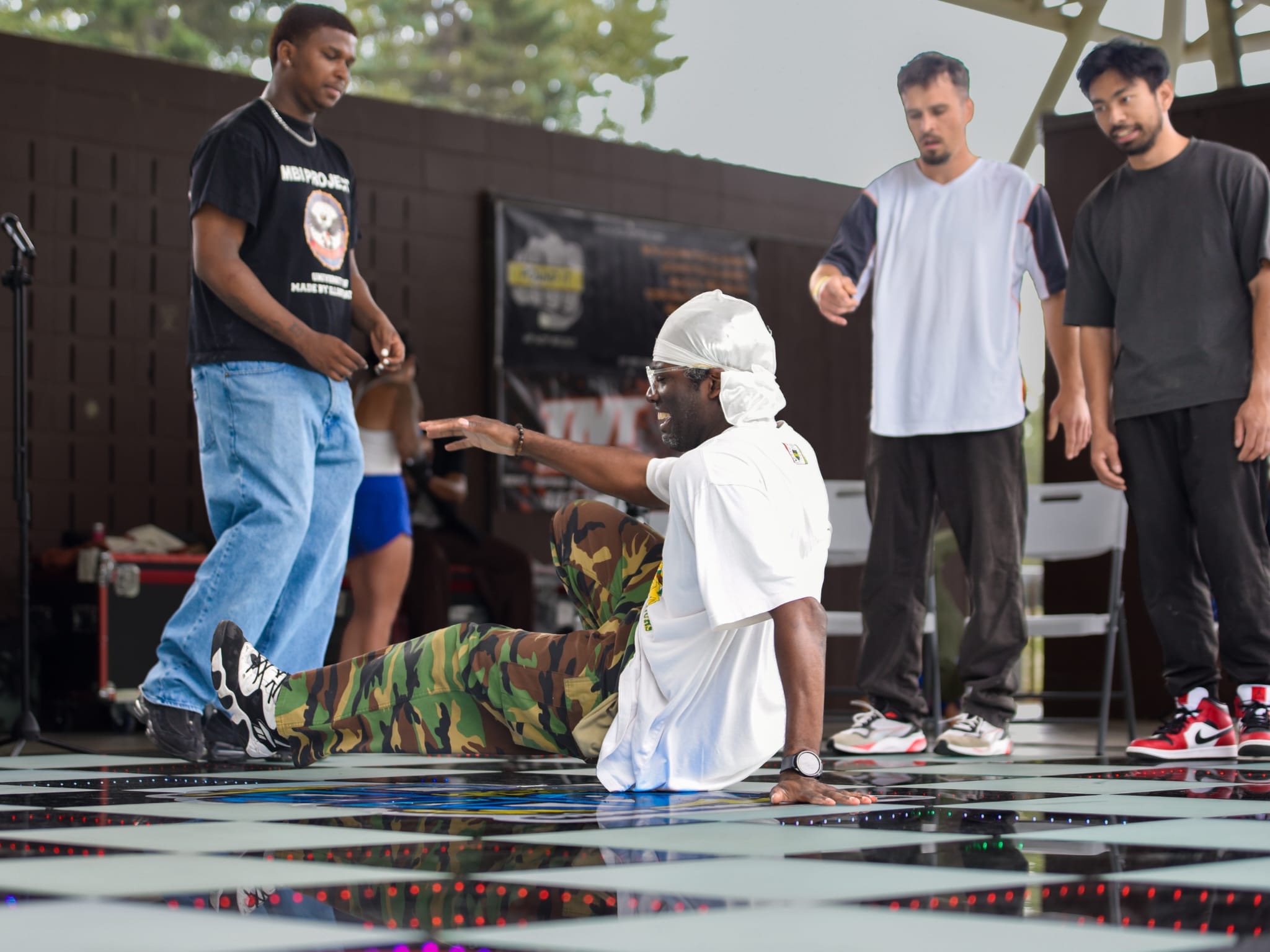 Dancer performing a floor move inside an outdoor battle circle